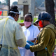 Local residents fill out paperwork at a mobile COVID-19 testing station by St. John’s Well Child and Family Center on April 28, 2020.